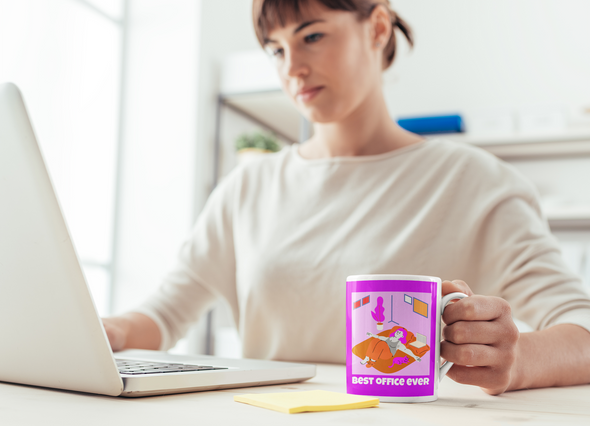 attractive woman working from home holding coffee mug that says BEST OFFICE EVER