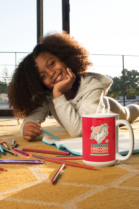coffee-mug-mockup-of-a-happy-girl-drawing-while-lying-on-the-floor-with unicorn coffee mug