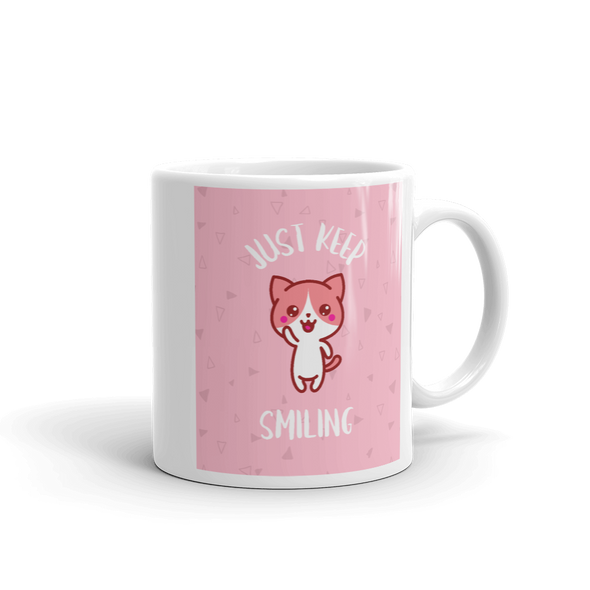 mug with waving cat and pink background that says JUST KEEP SMILLING