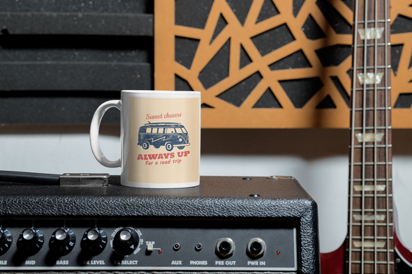 coffee mug says sunset chasers always up for a road trip with VW bus on a creme colored background