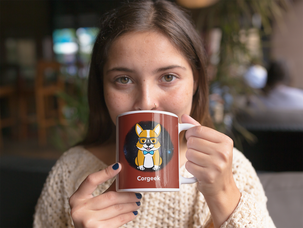 beautiful girl drinking a hot beverage from a mug with a corgi wearing glasses and a bow tie