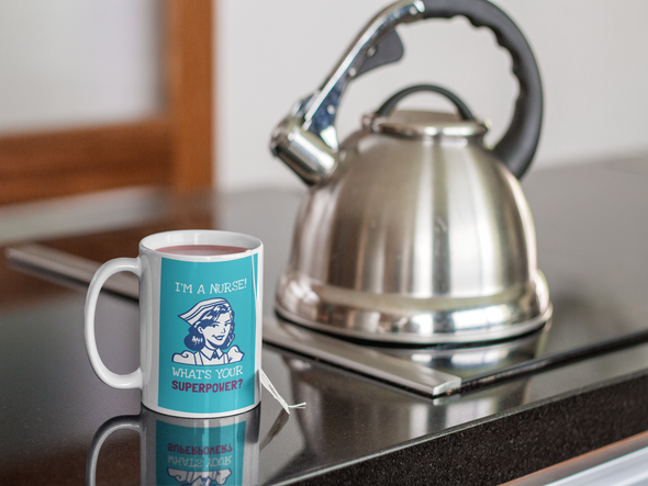 Mug with tea on a granite countertop with stainless steel teapot that says I'M A NURSE! WHAT'S YOUR SUPERPOWER?